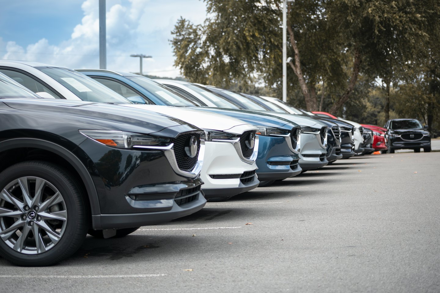 Rows of new SUVs parked neatly at an outdoor car dealership.